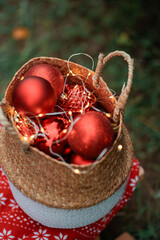 Cute little girl decorating Christmas tree in the forest. Winter holidays.