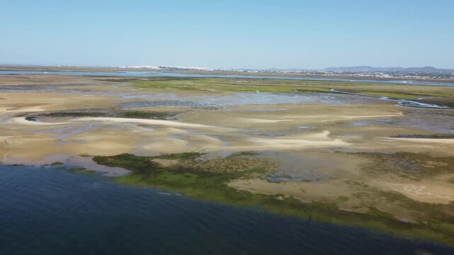 The riverbed of Ria Formosa in Algarve in Portugal. It is dried out at low tide