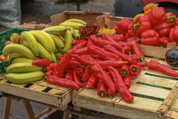 Bananas and red peppers on a wooden pallet at a street sale in Aarhus