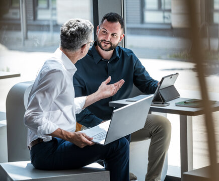 Manager and engineer having a business discussion in a modern office
