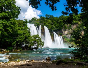 Obraz premium Lush waterfall cascading through a verdant forest