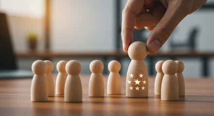 Hand placing wooden figure with stars among plain figures on a wooden surface in a bright setting