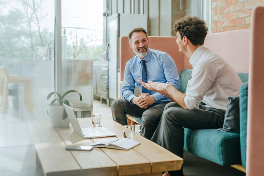 Businesspeople having a meeting and conversation in modern office