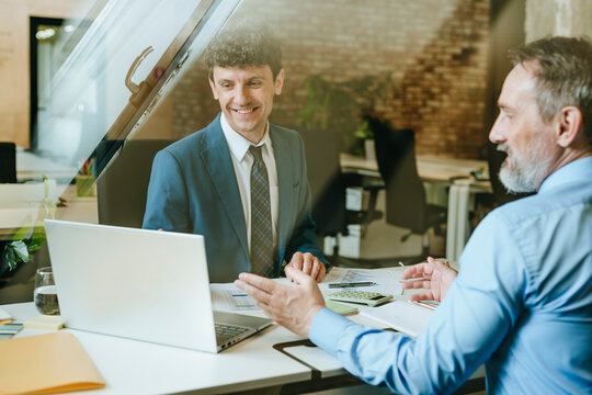 Business consultant meeting with client at desk in modern office