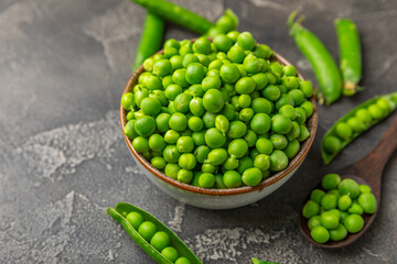 Fresh green pea pods with green peas on a wooden background. Sweet green peas. Green pea beans vegetables. Vegan. healthy vegetable. Copy space