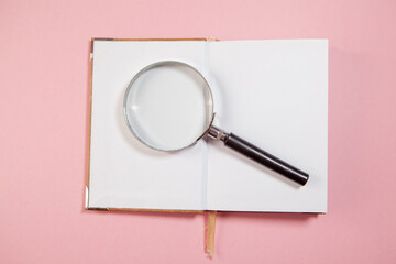 magnifying glass and pencil on table