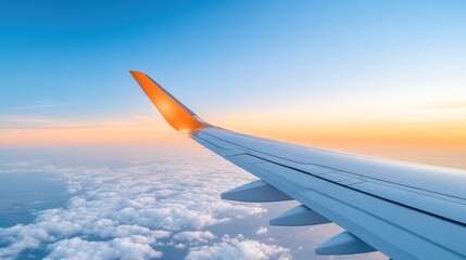 Obraz premium Sunset Flight: Aerial View of Wing Above Clouds