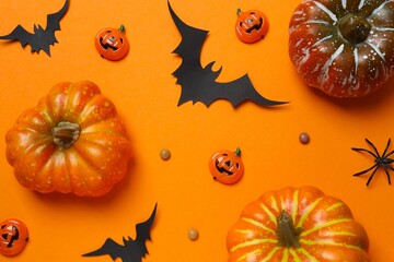 Happy Halloween holiday concept. Festive background design featuring bats, pumpkins, spider and confetti. 