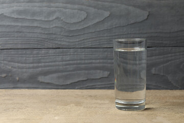 Glass with water on a wooden table. Drinking clear water 