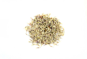 Flat lay view of dried White clover Trifolium repens blossom pieces of herbal tea powder, isolated on white background.
