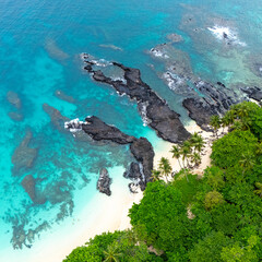 Tropical  Rolas Island on São Tomé aerial view with black volcanic rocks, white sand, turquoise...