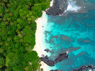 Tropical  Rolas Island on São Tomé aerial view with black volcanic rocks, white sand, turquoise...