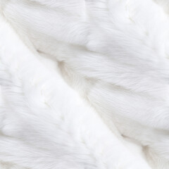 A close-up of a soft, white, fluffy material, likely faux fur or a similar fabric. The texture is...