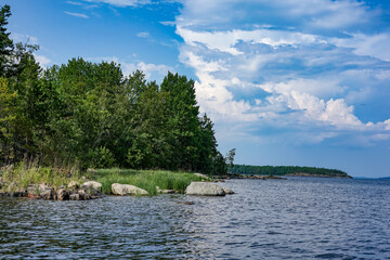  Scenic view of a lake with lush green trees and a partly cloudy sky