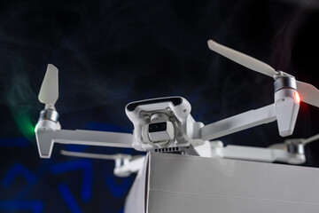 White Flying Drone with Camera on black background 