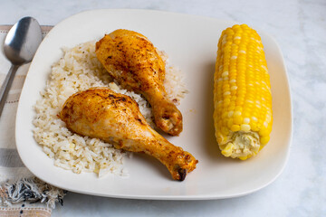 chicken drumsticks with rice and  corn
