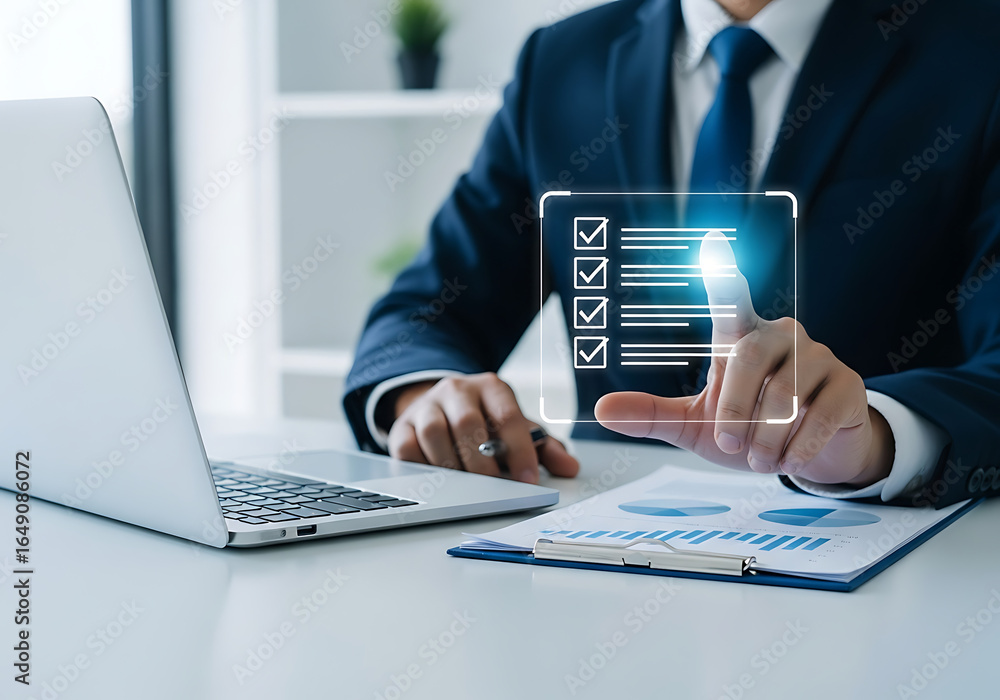 Poster businessman in a suit using a laptop and interacting with a digital checklist on a virtual screen in
