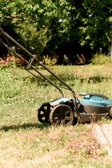 Photo of a lawn mower on a green lawn. Trees and grass are visible in the background. Perfect for...