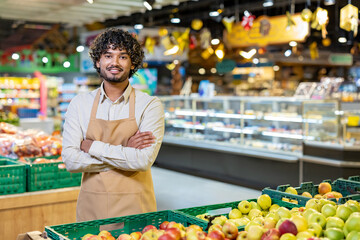 Friendly employee in a retail store displaying fresh fruits, representing customer satisfaction and quality produce. This individual exudes professionalism and pride in their work