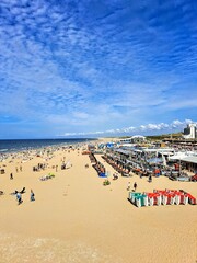 Scheveningen Beach, The Hague, Holland, Netherlands. Photo taken August 9, 2025. Sandy beach with people in sunny summer weather and blue sky with white clouds.