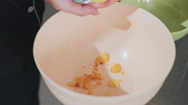 close up of pringles chips falling into bowl on kitchen counter, crispy snack food, golden fried potato chips, casual home cooking, crunchy tasty treat, snack preparation
