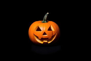 Obraz premium Happy Halloween Jack-o'-lantern carved pumpkin smiling face isolated on black background