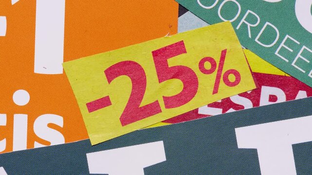 Close-up stop motion of sale stickers and percent signs, retail advertising loop