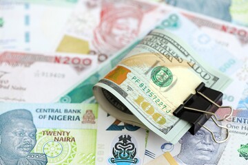 Nigerian naira currency money bills and bunch of us dollar banknotes. The concept of economics and...