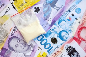 Philippines peso currency money bills and cocaine pack. The concept of drug trafficking