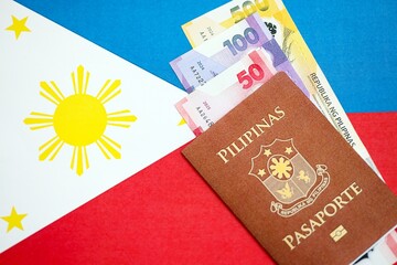 Philippines peso currency money bills and passport lies on flag. The concept of travel and vacation