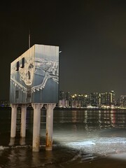 Modern Art Installation by the Sea at Night