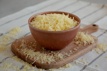 Organic Grated Cheese Mix in a Bowl, side view. Close-up.