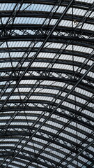 Industrial beam ceiling design of a train station in London. Leading lines and radial steel beams supporting the complex architectural structure. 