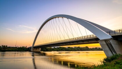 Obraz premium Modern Arch Bridge at Sunset Over Calm River
