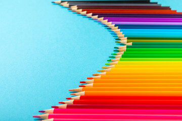 Colored pencils on a bright colored background. Equipment for coloring. Stationery for...