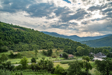 Stunning mountain view with lush green hills and cloudy sky in a serene rural landscape