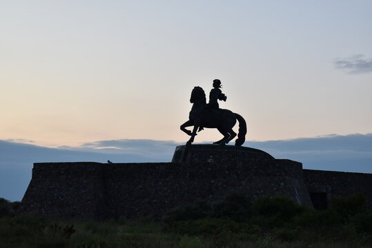 Horse statue silhouette with rider against evening sky   - Powered by Adobe