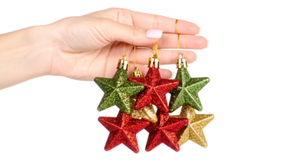 hand displaying colorful star-shaped Christmas toys on fingers isolated against a transparent background emphasizing holiday decorative themes isolated on transpaent background