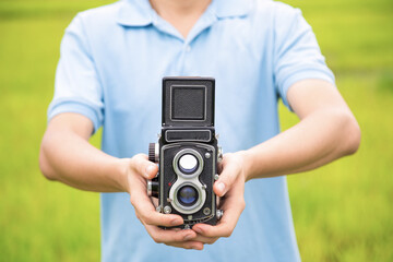 Photographer or traveller using a classic TLR (Twin Lens Reflex Cameras) in the nature for...