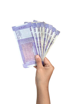 Hand holding multiple Indian 100 rupees currency notes in a fanned spread, isolated on a transparent background. financial success,banking, Indian economy.
