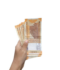 hand holding multiple Indian 200 rupees currency notes on transparent background, savings, and cash transactions