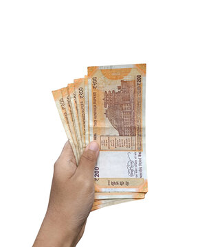 hand holding multiple Indian 200 rupees currency notes on transparent background, savings, and cash transactions