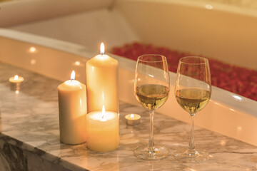 Two glasses of champagne with candle near jacuzzi. Valentines background. Romance concept.