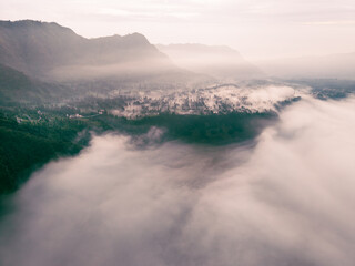 Mount Bromo in the morning amongst clouds. Morning sky