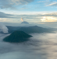 Mount Bromo in the morning amongst clouds. Morning sky
