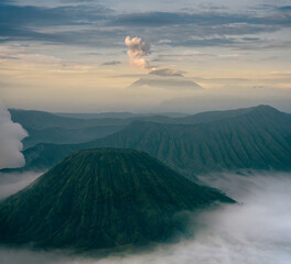 Mount Bromo in the morning amongst clouds. Morning sky