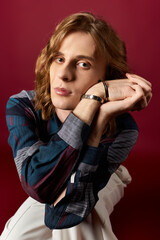 Handsome young man showcasing feminine fashion style in a modern setting