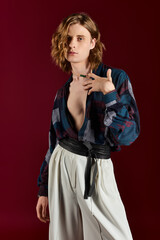 Fototapeta premium Handsome young man showcasing bold fashion choices and unique style against a vibrant backdrop