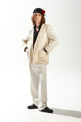 Fashion forward feminine man showcasing style in a trendy outfit and modern accessories