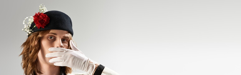 Fashion forward young man showcases elegant style in a striking fashion pose